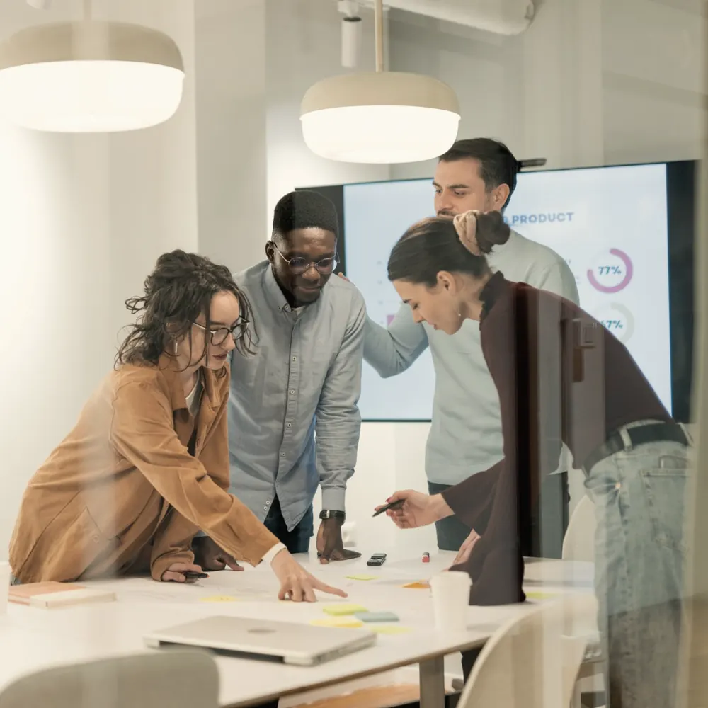 A small team working through a plan together around a table