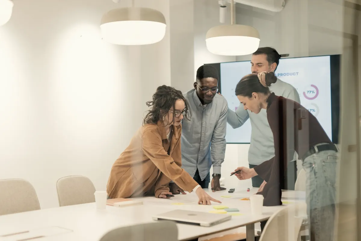 A small team working through a plan together around a table